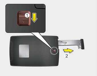 Push and hold the release lever (1) and remove the mechanical key (2). Insert
