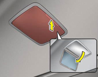 To use the rear vanity mirror, press the cover and it will slowly open and the