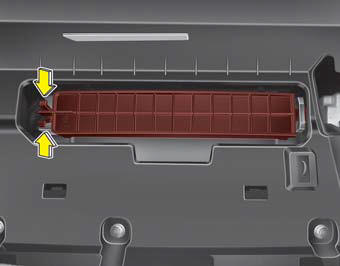 3.Remove the climate control air filter cover while pressing the lock on the