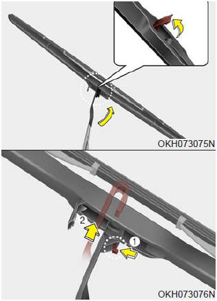 2.Turn the wiper blade clip. Then lift up the blade clip.